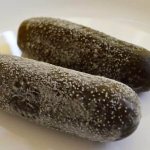 Why does a white coating appear on pickled cucumbers and is it possible to eat them?